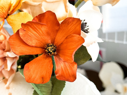 Close-up of an orange cosmos sugar flower with a blurred background